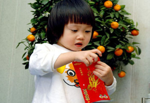 A child receives lucky money in a red envelope for chinese new year