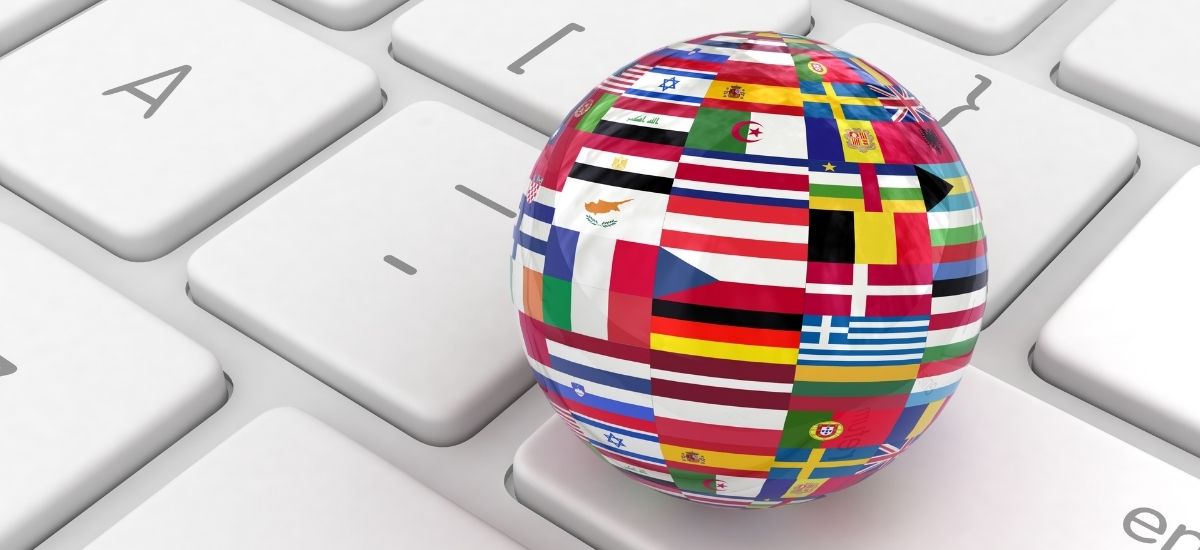 globe with flags on keyboard indicating translation services in Canada